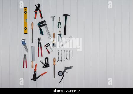 tools on the wall like hammer, pliers, saw, file Stock Photo