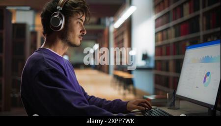Thoughtful European College Student Using Desktop Computer to Study in a Public Library. Handsome Man Learning Online, Reading a Marketing Presentation and Getting Ready for Exams. Close Up Portrait Stock Photo