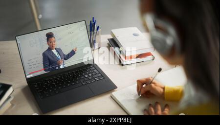 Over the Shoulder Shot with a College Student Studying Engineering in a Library. Anonymous Female Learning Online, Getting Ready for Technical Exams Stock Photo