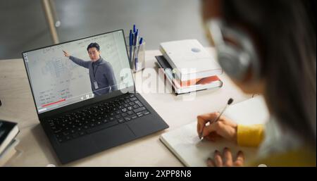 Over the Shoulder Shot with a College Student Studying Engineering in a Library. Anonymous Female Learning Online, Getting Ready for Technical Exams Stock Photo