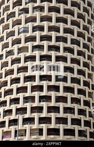 Repeated pattern of a high buidling facade with windows and frame in crowded urban life for low income classes Stock Photo