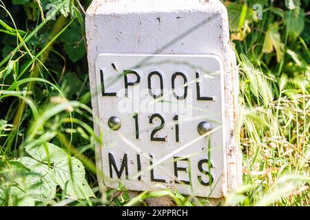 Milepost on towpath of Leeds and Liverpool canal in Rodley, Leeds showing the distance to Liverpool which is 121 miles Stock Photo