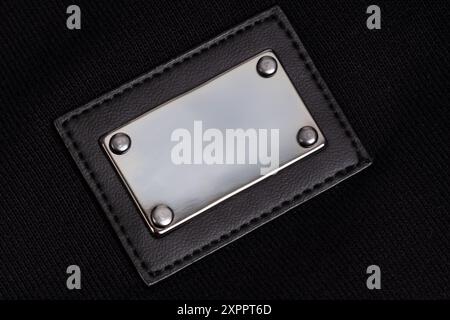 Shiny Metal Plate on Black Fabric Stock Photo
