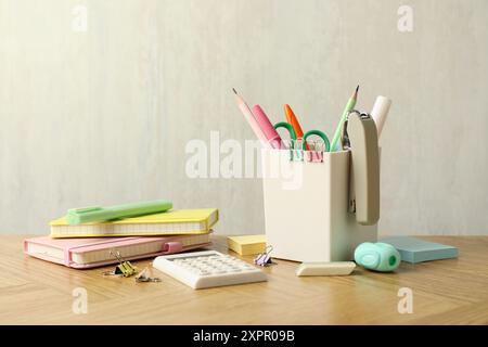 Stapler, holder and other different stationery on wooden table Stock Photo