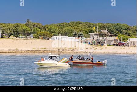 small us coast guard boat talking with a recreational boater in montauk, ny Stock Photo