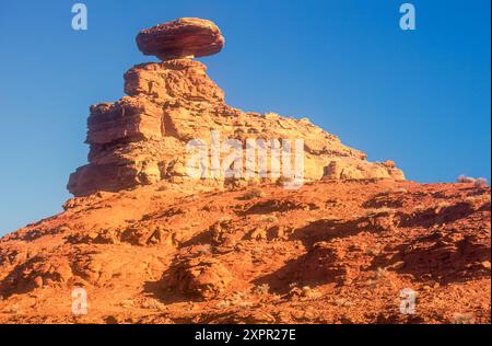 Sunlit Mexican Hat balanced rock formation at sunrise on Navajo Nation land in Mexican Hat, Utah. (USA) Stock Photo