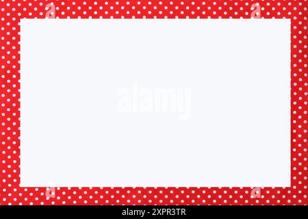 Bright red fabric material with a white polkadot pattern. Backgrounds. Stock Photo