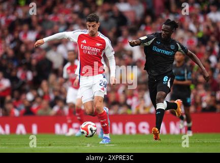 Arsenal's Kai Havertz (left) and Bayer Leverkusen's Odilon Kossounou in action during the pre-season friendly match at the Emirates Stadium, London. Picture date: Wednesday August 7, 2024. Stock Photo