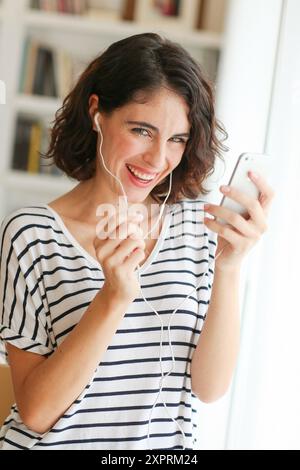 Woman listening music with Smartphone Stock Photo