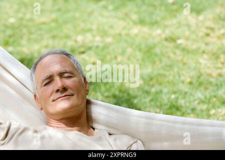 Adult, Adults, Calm, Calmness, Caucasian, Caucasians, Chill out, Chilling out, Closed eyes, Color, Colour, Contemporary, Daytime, exterior, Eyes shut, Stock Photo