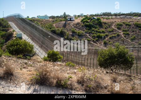 A high-security border fence in Melilla, a Spanish enclave, part of the European Union's external border. The six-meter-high wire fences, monitored by infrared cameras and sensors, create a formidable barrier. Photographed in June 2012. Stock Photo