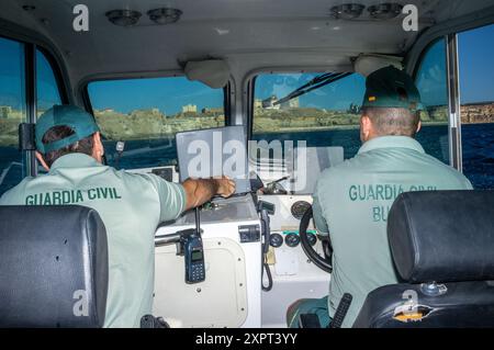 Guardia Civil officers overseeing the European Union's external border near the Spanish enclave of Melilla in June 2012, captured during a patrol mission. Maritime security and border control operations depicted. Stock Photo