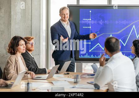 Businessman Presenting Upward Trend Graph During Meeting in Modern Office Stock Photo
