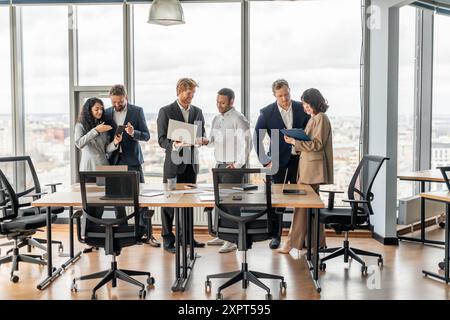 Business Professionals Collaborating In Modern Office With City View Stock Photo