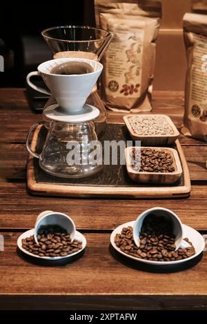 Coffee brewing setup maker, cups filled with coffee beans. Soft selective focus Stock Photo