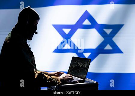 Mossad military expert using laptop, operating air defense system designed to counter missiles threatening country. Incognito Israeli intelligence operative in control room defends against rockets Stock Photo