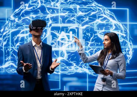 Technicians use VR smart goggles and AI neural networks to solve company problems. IT specialists using artificial intelligence and AR virtual reality tech to visualize startup business data Stock Photo