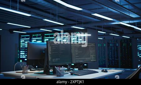 Server rows and computer used to ensure optimal performance and reliability, managing gear. High tech data center facility used for overseeing network connections, panning shot Stock Photo