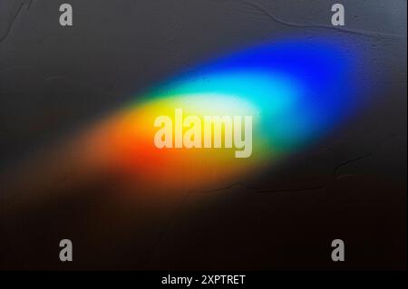 Refracted sunlight through stained glass window creates a prism of rainbow colors Stock Photo