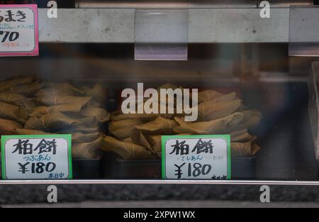 Traditional handmadeKashiwa mochi dispaly in the store. it's a wagashi (Japanese confection) of white mochi surrounding a sweet anko (red bean paste) Stock Photo