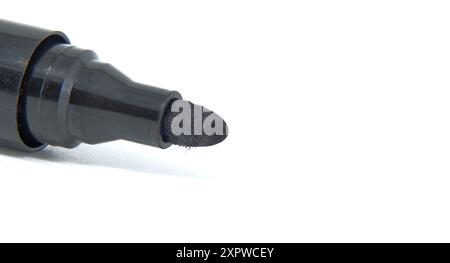 Detailed close-up of black permanent marker with white background. Ideal for office supplies, school projects, and art use. Stock Photo