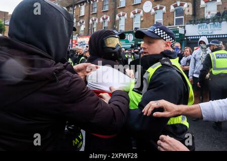 London, UK. 07th Aug, 2024. Police remove a protestor gathered for an Anti-Racism demonstration in reaction to reports of a far-right gathering. Credit: SOPA Images Limited/Alamy Live News Stock Photo