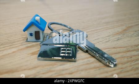 model of house and keychain with a home key representing buying a new home Stock Photo