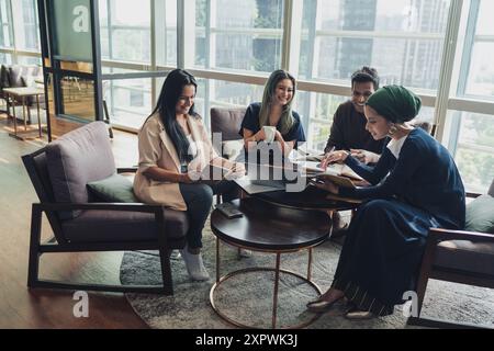 Diverse Asian business executives including a disabled man in wheelchair having a casual meeting Stock Photo