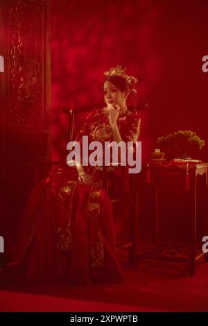 Beautiful Asian woman in traditional wedding tea ceremonial dress in studio Stock Photo