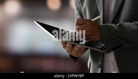 closeup man using his tablet touching screen device isolated screen ONLINE ADVERTISING Stock Photo