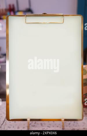 Blank white paper board on table in the kitchen, stock photo Stock Photo