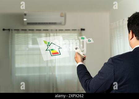 Energy Efficient House man use house icon with energy efficiency scale Invoice And Economy Stock Photo