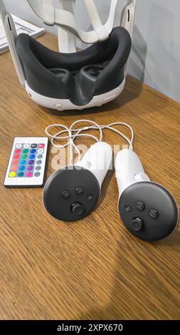 Virtual game set. VR headset. Glasses are on the table next to the control panel. Copy space Stock Photo