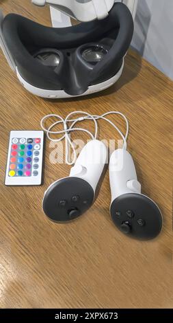 Virtual game set. VR headset. Glasses are on the table next to the control panel. Copy space Stock Photo