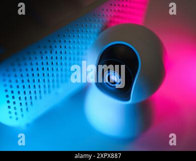 Security smart home monitoring camera. White devices neon lights. Stock Photo