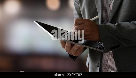closeup man using his tablet touching screen device isolated screen ONLINE ADVERTISING Stock Photo