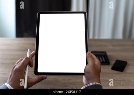 hands of a man holding blank tablet a mockup. iPad digital tablet workspace table Stock Photo
