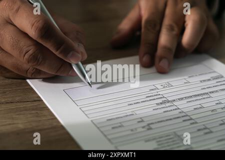 businessman signs form agreement writing on paper Signing contract Stock Photo