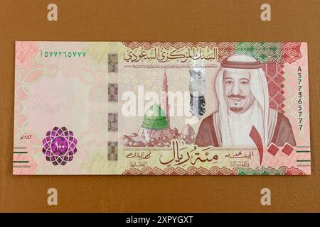 Saudi Arabia one hundred riyals banknote obverse side features green dome of the Prophet's Mosque, Medina and King Salman portrait. Stock Photo