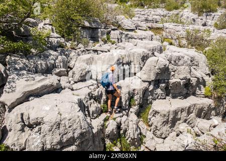 Climbing limestone fissures to Subra peak, Orjen Mountains, Herceg Novi, Montenegro Stock Photo