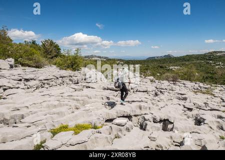 Climbing limestone fissures to Subra peak, Orjen Mountains, Herceg Novi, Montenegro Stock Photo