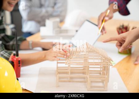 Architects are collaborating on a house design at the office Stock Photo