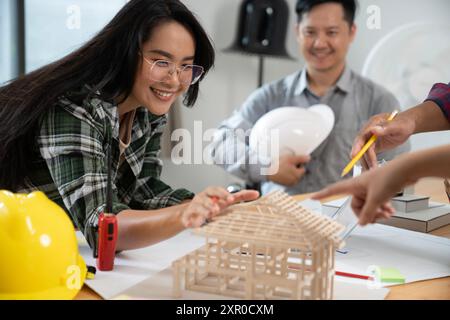 Architects are collaborating on a house design at the office Stock Photo