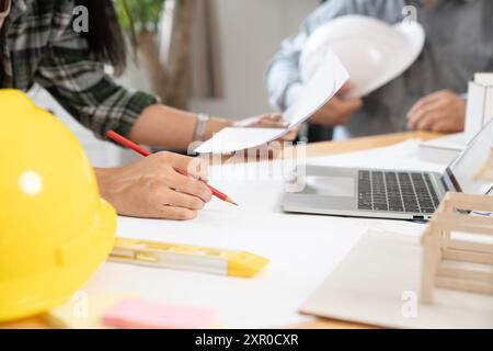 Architects are collaborating on a house design at the office Stock Photo