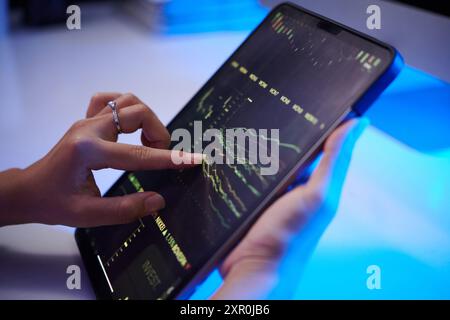 Analyzing Financial Data on Digital Device Stock Photo