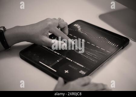 Analyzing Financial Data on Digital Tablet Device Stock Photo