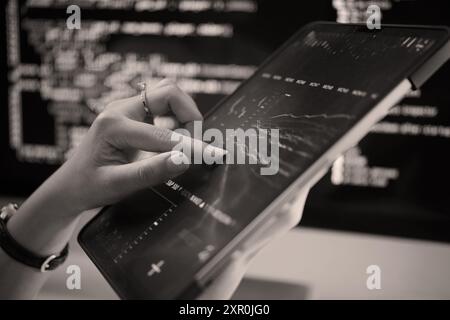 Analyzing Data on Tablet Using High-Tech Tools Stock Photo