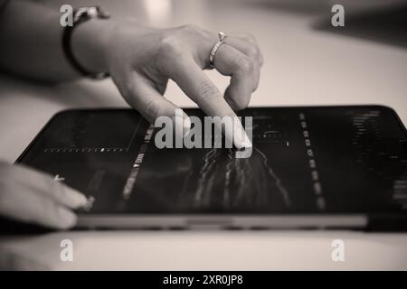 Analyzing Financial Data Using Tablet on Desk Stock Photo
