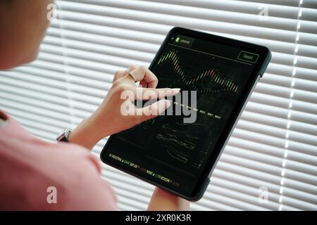 Analyzing Stock Market Trends using Tablet Technology Stock Photo