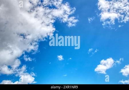 Clouds against a vivid blue sky on a summers day in June in the UK Stock Photo